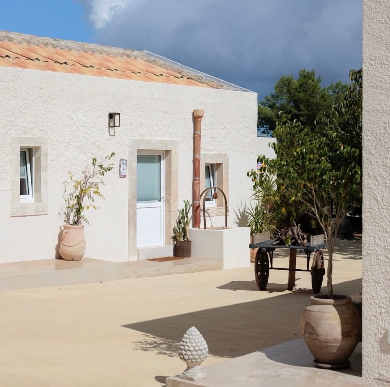 Inner courtyard with long communal table set for an estate dinner